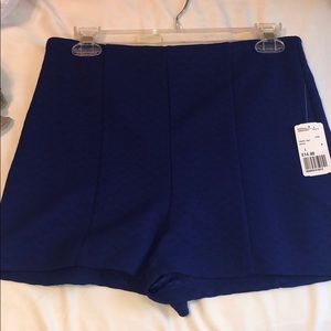 Royal blue high-waisted shorts.